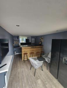 a living room with a table and some chairs at Cosy Worsley Home with a Garden Bar! in Manchester