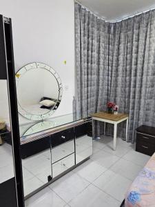 a bedroom with a dressing table and a mirror at Master Bedroom in Ajman 
