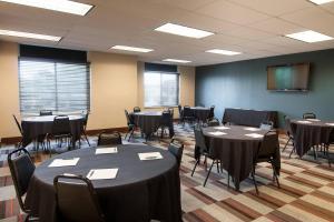 a conference room with tables and chairs and a screen at Four Points by Sheraton Columbus-Polaris in Columbus