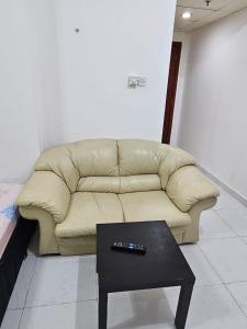 a living room with a couch and a coffee table at Master Bedroom in Ajman 
