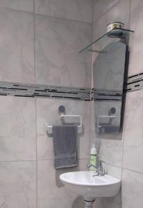 a bathroom with a sink and a mirror at Villa Chungos in Quebrada Ganado