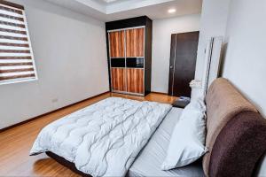 a large bed in a room with a couch at There's no place like home! By Mizu Homestay. in Miri