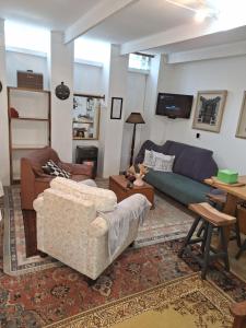 a living room with a couch and a table at Rhus Cottage. in Stanford