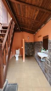 a bathroom with two toilets and a sink and a staircase at Suka Beach Bungalow in Nusa Lembongan