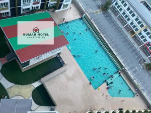 an overhead view of a pool with people swimming in it at Mahkota Valley (Rumah Hotel) in Kuantan