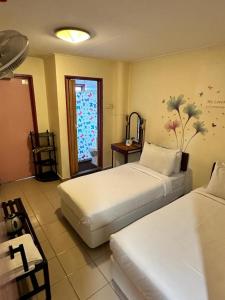 Postel nebo postele na pokoji v ubytování Hotel BB Inn @ Cameron