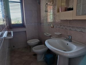a bathroom with a sink and a toilet at Residence La Playa in Marina di Camerota