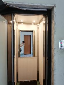 a hallway with a mirror and a person taking a picture at I Sogni Di Leo in Turin