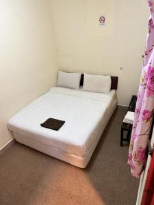 Postel nebo postele na pokoji v ubytování Hotel BB Inn @ Cameron