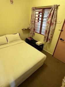Postel nebo postele na pokoji v ubytování Hotel BB Inn @ Cameron