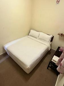 Postel nebo postele na pokoji v ubytování Hotel BB Inn @ Cameron