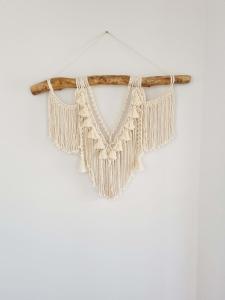 a beaded fringe necklace hanging on a stick at Surfmist House in Robe
