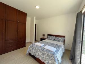 a bedroom with a bed with two towels on it at Brand new Holiday Villa - 3 bedroom 4 bathroom in Baños