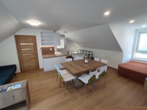 a kitchen and dining room with a table and chairs at apartmánový dom rodiny BÖJTÖS Patince in Patince