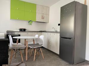 uma cozinha com uma mesa e um frigorífico em Matesevo Home em Mateševo