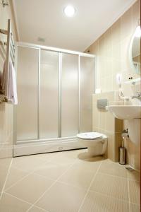 a bathroom with a shower and a toilet and a sink at Sefa Hotel 2 Çorlu in Çorlu