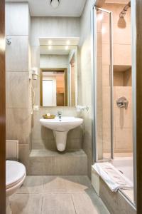a bathroom with a sink and a shower at Hotel Palladium in Odesa