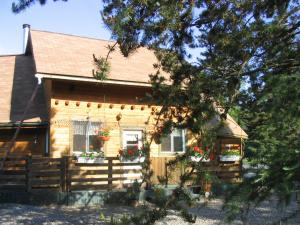 une maison en bois avec des fleurs dans la fenêtre dans l'établissement Domaine Summum, à Mont-Tremblant