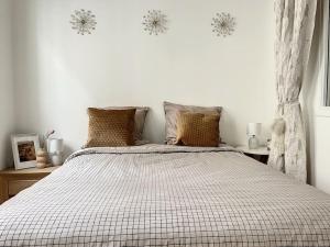 - une chambre blanche avec un grand lit et des oreillers dans l'établissement Le Huitième - Chic et Branché, à Compiègne
