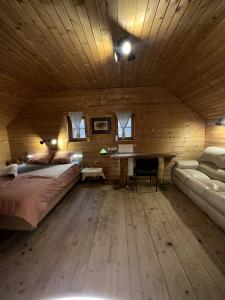 a bedroom with a bed and a desk in a room at Ranch Kaja & Grom in Vojnik