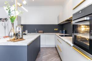 a kitchen with white cabinets and a counter top at Bank Apartments in Boston