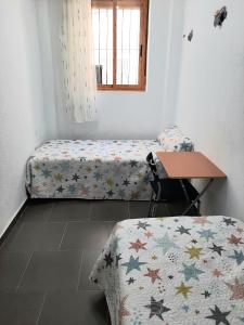 מיטה או מיטות בחדר ב-Casa planta baja