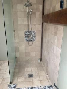 a shower with a glass door in a bathroom at The Granary at Duchess Farm in Sawbridgeworth