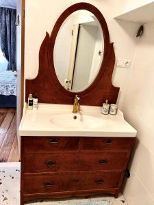 a bathroom with a sink and a mirror at Juveliera apartamenti in Kuldīga +11 photos