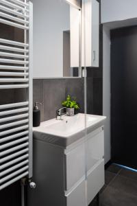 a bathroom with a white sink and a mirror at Cris Apartments in Târgu-Mureş +37 photos