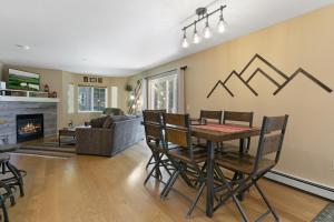 a living room with a table and chairs and a fireplace at 901 Crazy Horse Circle condo in Edwards
