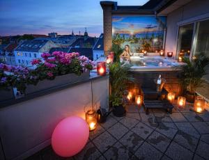 a woman standing in a bath tub on a balcony at Mortens Kro Boutique Hotel in Aalborg