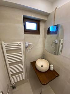 a bathroom with a sink and a mirror at Marousos Central Guesthouse in Portariá