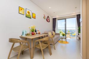 a dining room and living room with a table and chairs at The sóng Remy Apartment in Vung Tau