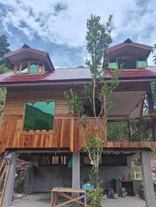 a tree house with a balcony on top of it at Little Cabins at Km 499 
