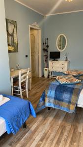 a bedroom with a bed and a desk and a table at B&B Villa Botto in Cossato