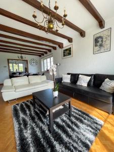 ein Wohnzimmer mit einem Sofa und einem Couchtisch in der Unterkunft Gîte forêts et lacs in Puttelange-aux-Lacs
