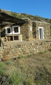 a stone building with a window on top of it at Dammusino: mini-appartamento in Pantelleria +3 photos