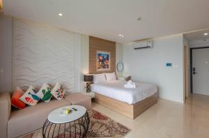 a hotel room with a bed and a couch at Vinhomes Dcapital Tran Duy Hung Official in Hanoi