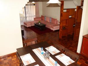 a living room with a table and a couch at KenGen Furnished and Serviced Apartments in Nairobi