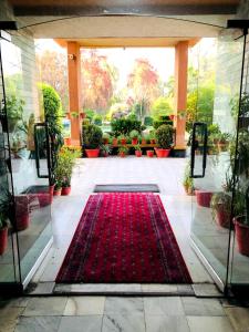 a red carpet in the middle of a courtyard with a red rug at Spinghar Royal Hotel in Jalalabad 