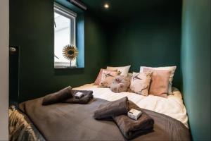 a bedroom with a large bed with green walls at Cozy 2-bedroom apartment in Amsterdam