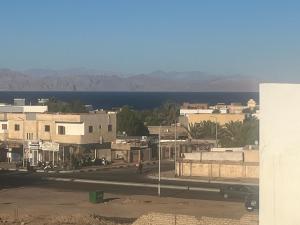 a view of a city with the ocean in the background at Malaz Motel in Dahab