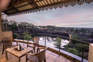 a balcony with a table and chairs and a view of a river at Waterstone resort 
