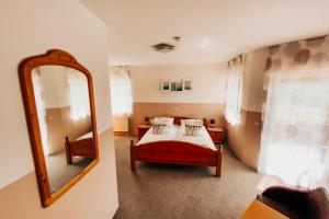 a bedroom with a bed and a mirror at Gästehaus Windhagen in Windhagen