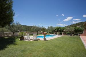 a yard with two chairs and a swimming pool at Coatmeur brunette jean marie in Cabasse