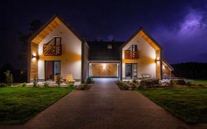 a house at night with the lights on at Domki Szczyt Beztroski - Balia & Sauna in Nowy Targ