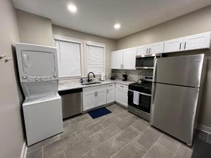 a kitchen with stainless steel appliances and white cabinets at Midtown Hideaway: Just 3 miles from Everything! in Memphis