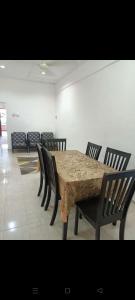 a dining room with a table and chairs at Leeza Homestay in Kampung Kempadang