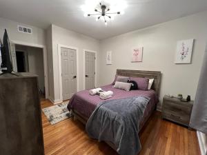 a bedroom with a bed with two towels on it at Midtown Hideaway: Just 3 miles from Everything! in Memphis