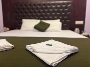 a bed with two white shirts on a table at Purnima Resort Neil Island in Neil Island +69 photos